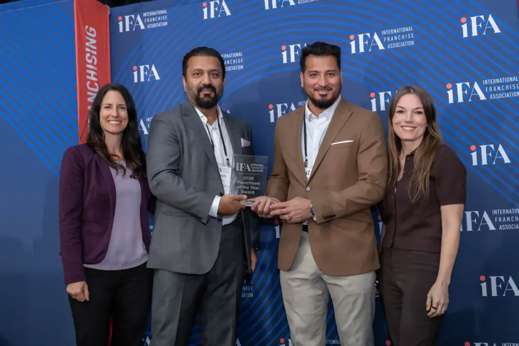 Zargham Amid and Mustafa Durrani pose with the award for 2026 IFA Franchisees of the Year.